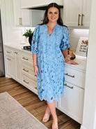 Close-up of the V-neckline and elbow-length sleeves of the Pamela Poppy Maxi Dress by Buddy Love, showcasing elegant soft elastic cuffs.