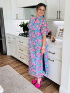 Model wearing the LEIGHTON PANSY MAXI DRESS BY BUDDY LOVE, highlighting its elegant two slits and ankle-length silhouette.