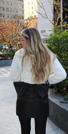 Stylish Black Bow Skirt by Aurea Lux Collective featuring a bold black color and a striking bow detail on the backside.