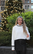 Trendy Black Bow Skirt showcasing its convenient side zip and fashionable design, perfect for elevating your wardrobe.