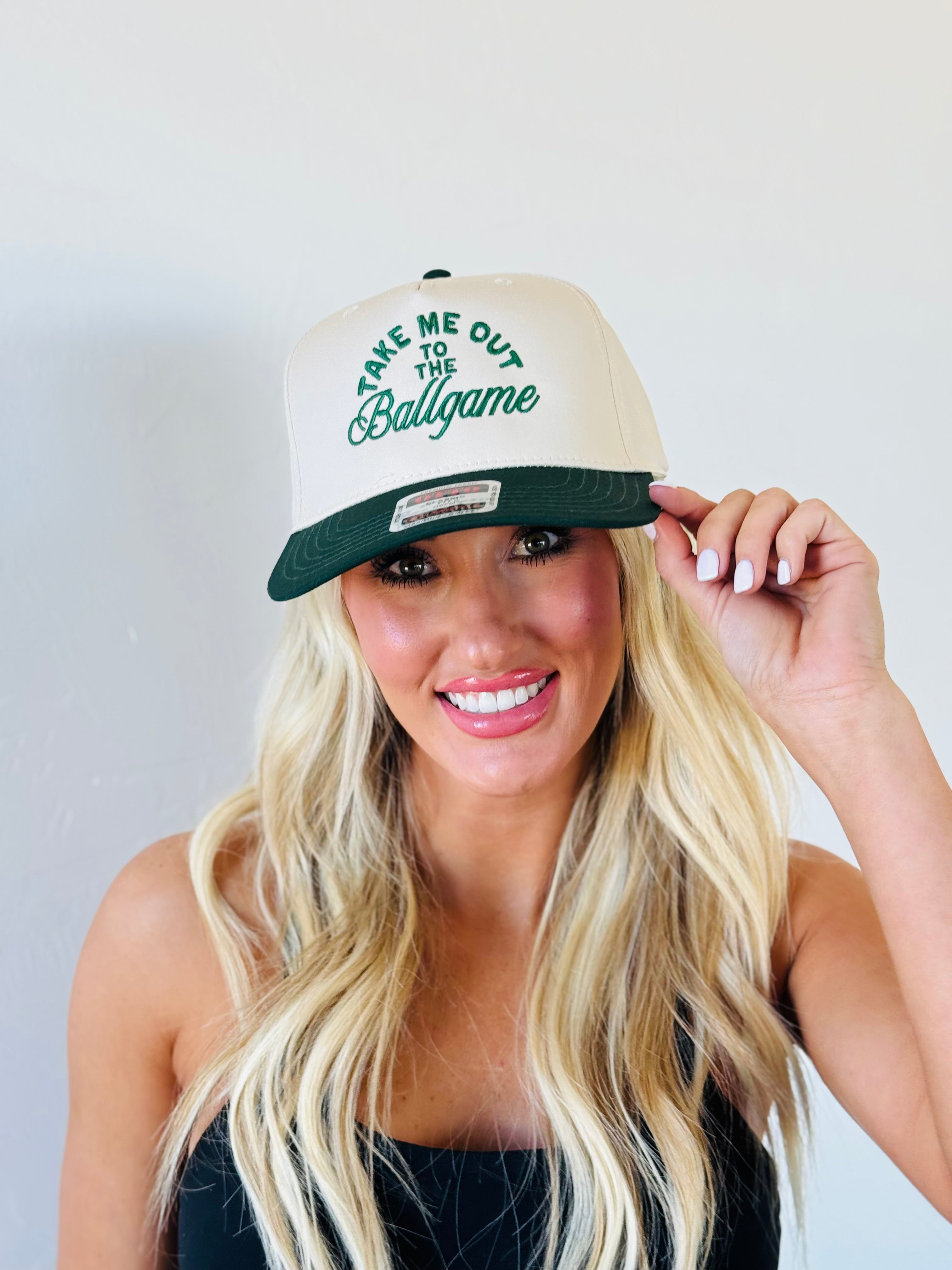 TAKE ME OUT TO THE BALLGAME TRUCKER HAT worn outdoors, emphasizing its trendy design and comfort.