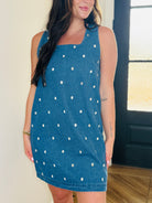 Close-up of the clear jewels on the sleeveless denim dress by Entro, showcasing its chic design.